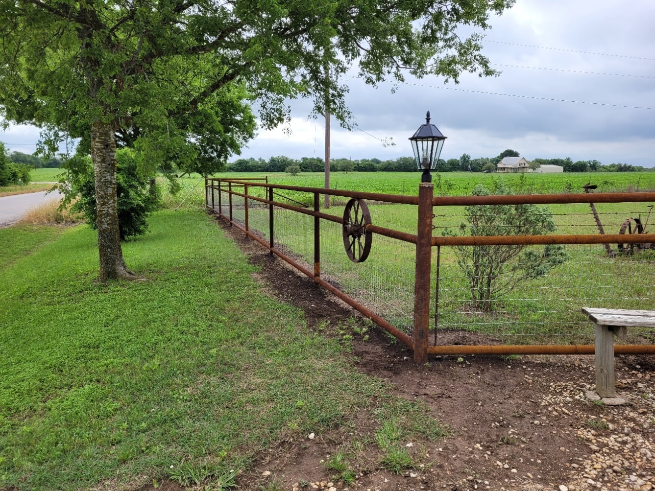 Rustic Ranch Pipe Fence with Wagon Wheel — Bell County, TX